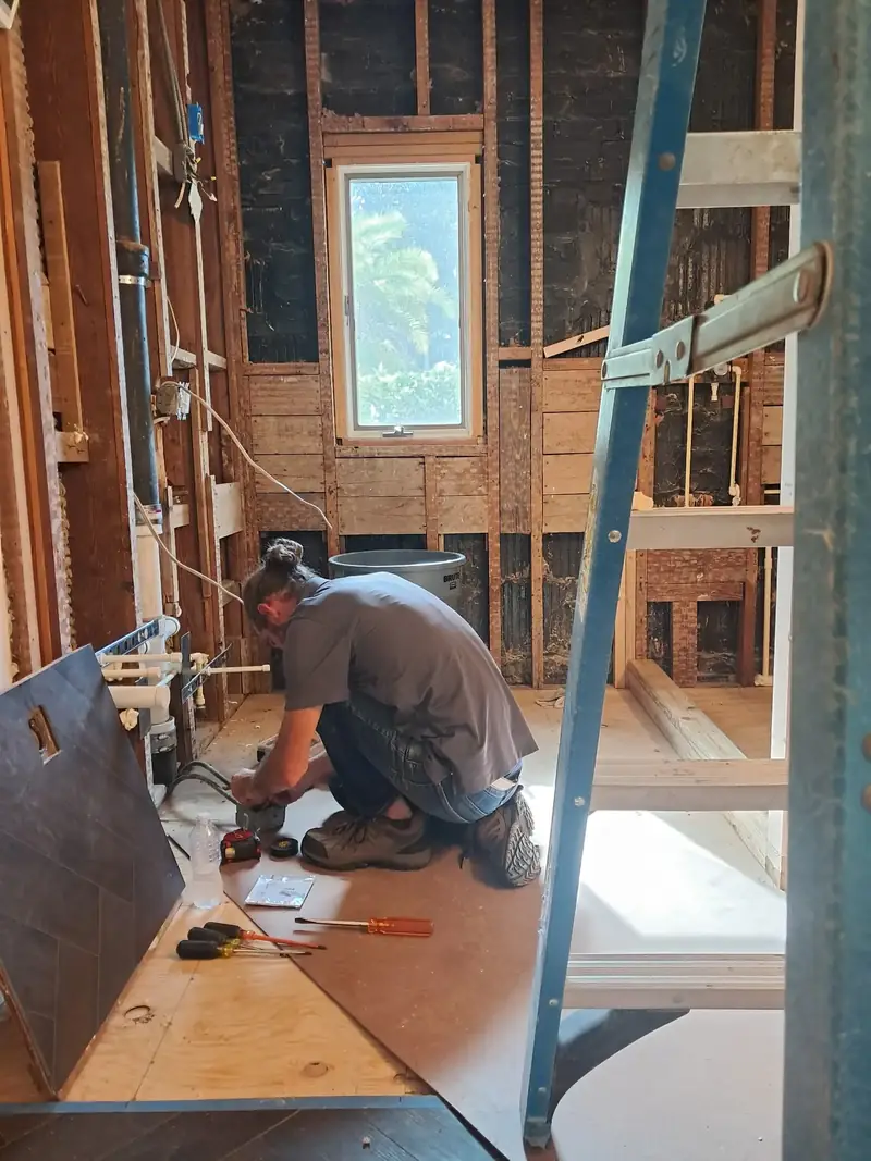 Residential wiring and remodels Kincaid Electric electrician kneeling in a framed room during residential wiring